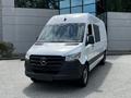 A white 2019 Mercedes-Benz Sprinter van with a black front grille and windows, featuring a sleek design and large cargo space
