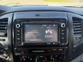 A 2015 Toyota Tacoma dashboard with a touchscreen display showing radio information and song details