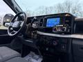 Interior view of a 2023 Ford F-250 showing the dashboard with digital display touchscreen and various controls including a radio and climate settings