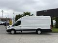 A white 2017 Ford Transit van with a high roof and black accents parked on a paved surface