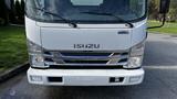 A 2016 Isuzu NPR truck front view with a white exterior and chrome grille showcasing the Isuzu logo