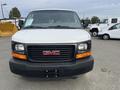 Front view of a 2012 GMC Savana van showcasing its white exterior and black grille with the GMC logo