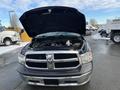 A 2015 RAM 1500 with the hood open displaying the engine compartment and various components inside