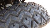 Close-up of the rugged tire of a 2016 Polaris Ranger 570 Crew showing a deep tread pattern designed for off-road traction