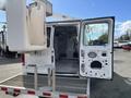 A white 2008 Ford Econoline van with an open rear door and a bucket lift attached to its top