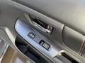 Interior door panel of a 2021 Subaru WRX featuring window control buttons and a door handle