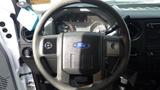 Steering wheel of a 2016 Ford F-550 with a Ford emblem and various controls visible on the dashboard