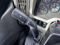 A close-up of the gear shift lever of a 2008 International 7500 showing various settings and indicators for low and high gears