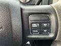 Steering wheel controls of a 2015 RAM 1500 featuring buttons for on/off, resume, cancel, and set functions