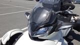 Close-up of a 2013 Can-Am Spyder showcasing its sleek front design and windshield with integrated headlights