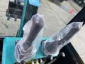 Close-up of two joystick controls wrapped in plastic on the operator's panel of a 2024 AGT Industrial QH13R Mini Excavator