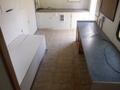 2004 Royal 18 Foot Office Trailer featuring a linoleum floor with a large white table against a wall and a grey countertop on the opposite side
