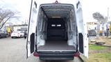 The interior of a 2024 Mercedes-Benz Sprinter 2500 van showing a spacious cargo area with high ceilings and side doors fully opened