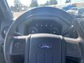 Steering wheel and dashboard of a 2014 Ford F-250 SD showing gauges and control buttons