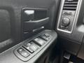 Close-up of the control panel on the driver's side door of a 2022 RAM 1500 Classic featuring window and door lock controls