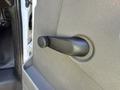 A black manual door handle for a 2021 Chevrolet Express mounted on a textured panel