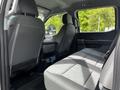 Interior view of a 2024 Ford F-550 showcasing two gray upholstered front seats and a spacious back seat area