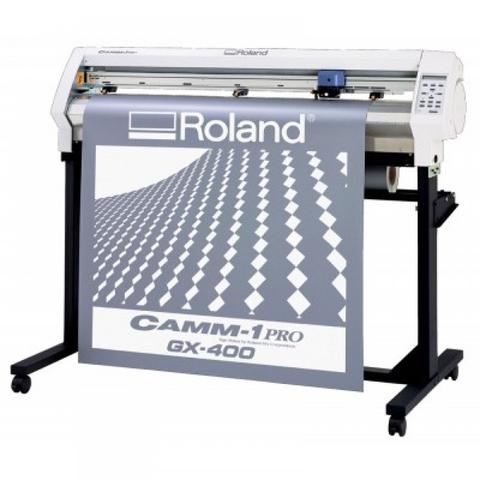 A Roland CAMM-1 GX-400 vinyl cutter with a large gray sheet displaying a geometric pattern and the model name in front of it