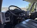 Interior view of a 2013 International 7400 truck showing the steering wheel dashboard controls and seating area