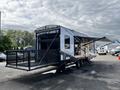 A 2022 Heartland Torque travel trailer with a large extendable awning and a rear ramp door for easy access to the interior and outdoor space