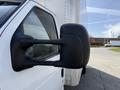 Close-up of the side mirror on a 2023 Ford E-450 truck showing its black casing and design