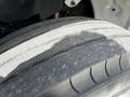 Close-up of a worn tire from a 2012 Freightliner M2 106 showing tread wear and surface texture