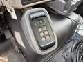 A close-up view of a gear shift control panel featuring buttons for neutral, reverse, and power settings in a 2016 International 7600 truck