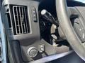 Dashboard controls of a 2012 Chevrolet Express featuring air vents a turn signal lever and various switches for lights and functions