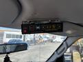 A control panel mounted on the ceiling of a vehicle featuring buttons for power and various functions related to warning systems