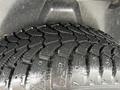 Close-up of a rubber tire with a deep tread pattern designed for traction and grip on various surfaces