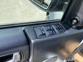 Close-up of the driver's side door panel of a 2006 Land Rover LR3 featuring window control buttons and a side mirror adjustment dial
