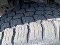 Close-up of a tire tread from a 2017 Ford F-150 showcasing deep grooves and rugged pattern designed for traction and durability