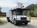 A white 2020 Freightliner M2 with a hydraulic lift system on top parked on a driveway