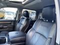 Interior of a 2017 RAM 1500 with black leather seats featuring a center console and armrest
