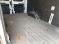 Interior of a 2022 Ford Transit cargo van featuring a spacious empty floor with a flat surface and a slight hump on one side