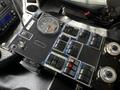 Control panel of a 2012 Autocar Xpert featuring various switches and gauges including a speedometer and toggle switches for different functions