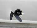 A close-up of the fuel cap of a 2016 GMC Savana showing the cap open revealing the fuel filler neck