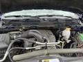 Engine compartment of a 2019 RAM 1500 Classic showing various components including the engine block hoses and battery.