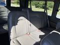 Interior view of a 2021 Chevrolet Express showing the back seat with gray upholstery and seat belts
