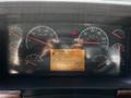Dashboard of a 2005 Volvo VND 122 displaying speedometer fuel gauge and various warning lights with a digital readout showing distance time and temperature