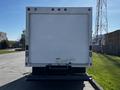 A white 2019 Ford Econoline cargo van viewed from the rear with a plain back door and no visible markings or features