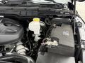 The image shows the engine compartment of a 2018 RAM 1500 featuring the engine block battery and other components such as the coolant reservoir and various hoses