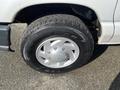 Close-up view of a 2008 Ford Econoline front wheel with a silver hubcap and a Goodyear tire featuring a tread pattern