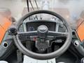 The interior view of a 2018 Doosan DL300-5 heavy machinery cockpit featuring a steering wheel, control levers, and various dashboard gauges