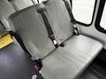 Interior view of two gray vinyl seats in a 2016 Ford Econoline with seatbelts and metal fasteners