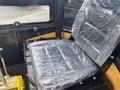 A 2024 AGT Industrial H13R Mini Excavator seat covered in plastic wrap showcasing a clear view of the controls beside it