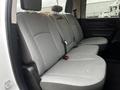 Interior view of a 2022 RAM 1500 Classic showing the rear bench seat with gray upholstery and seatbelts