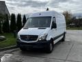 A white 2016 Mercedes-Benz Sprinter van parked with a high roof large cargo area and front grille featuring the Mercedes logo