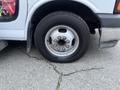 A close-up of a 2017 Chevrolet Express van's right front tire and wheel with a six-bolt pattern and visible tread on the tire