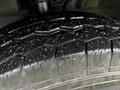 A close-up of a 2021 Ford Transit tire showing tread details and a slightly dirty surface
